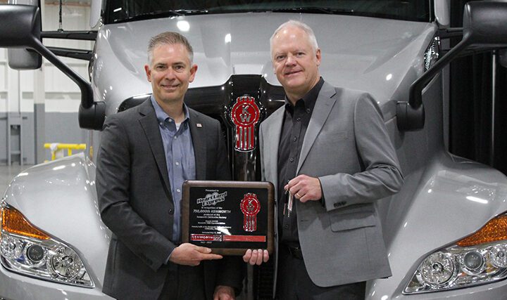 Kenworth General Manager Kevin Baney presents Heartland Express CEO Mike Gerdin with plaque and keys to #750,000