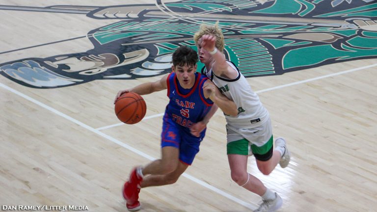 Roman Berry drives on Brennan Smith as Zane Trace defeats Huntington 58-44.