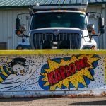 Medill Elementary’s winner of the 2025 People’s Choice Award, featuring a blade with a cartoon snowman, swirling snowflakes, and a comic-style exclamation ‘KAPLOW!’